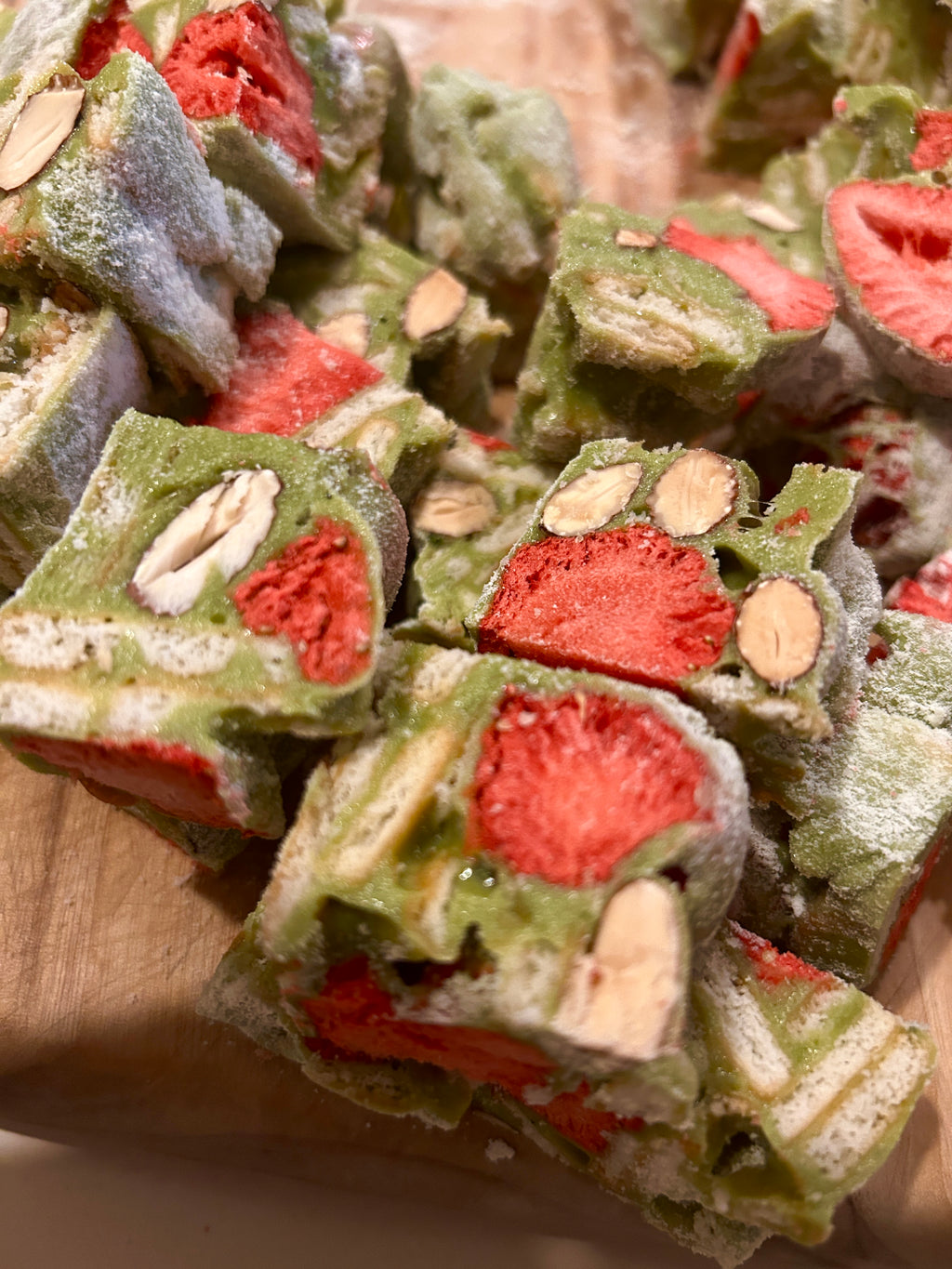 Handmade matcha strawberry nougat with crunchy biscuits, freeze-dried strawberries and roasted almonds
